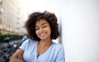 Young, pretty woman with straighter teeth thanks to Invisalign